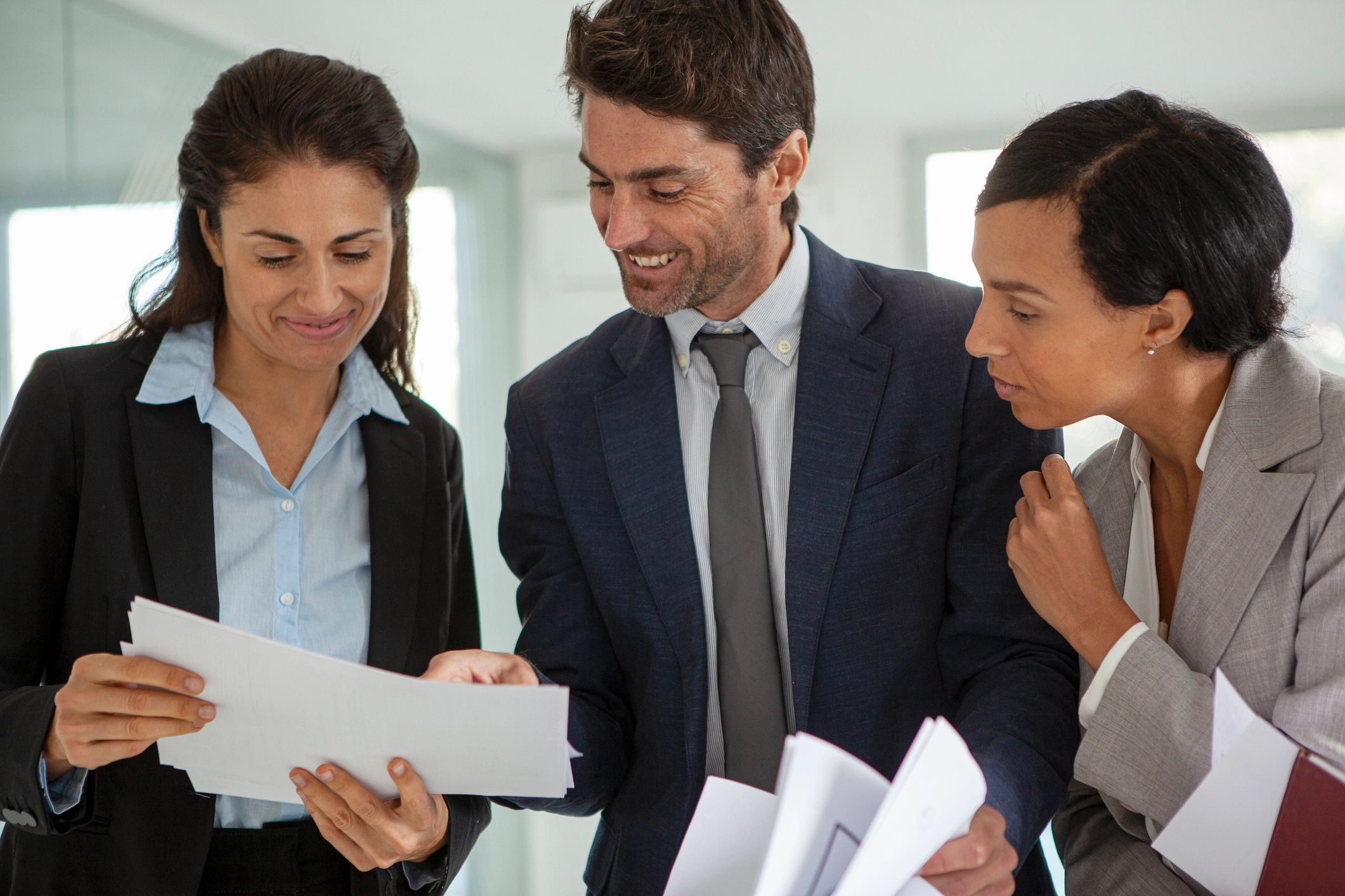 Business leaders reviewing governance documents during a planning meeting