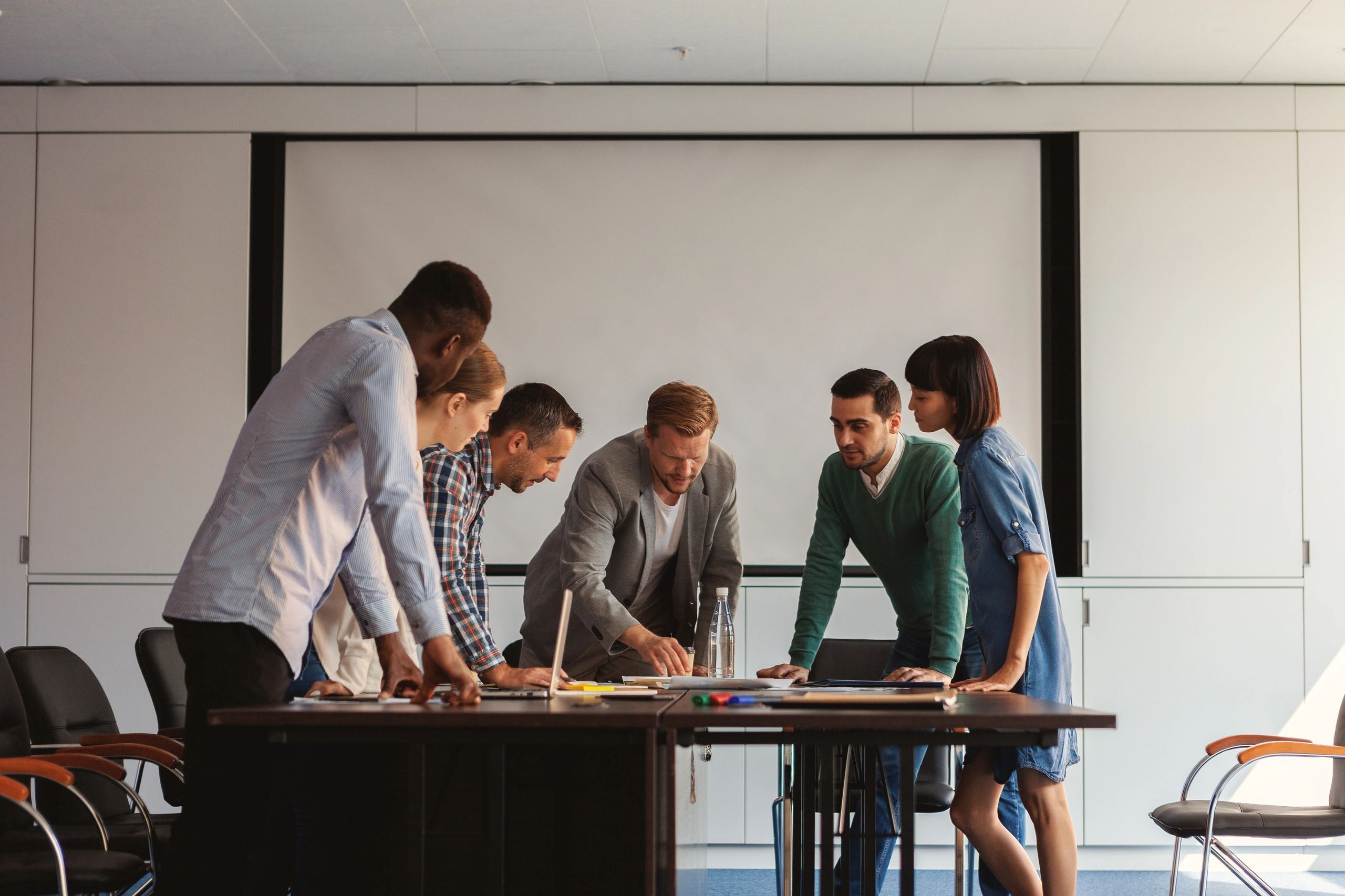 Consulting team collaborating around a table to improve business operations