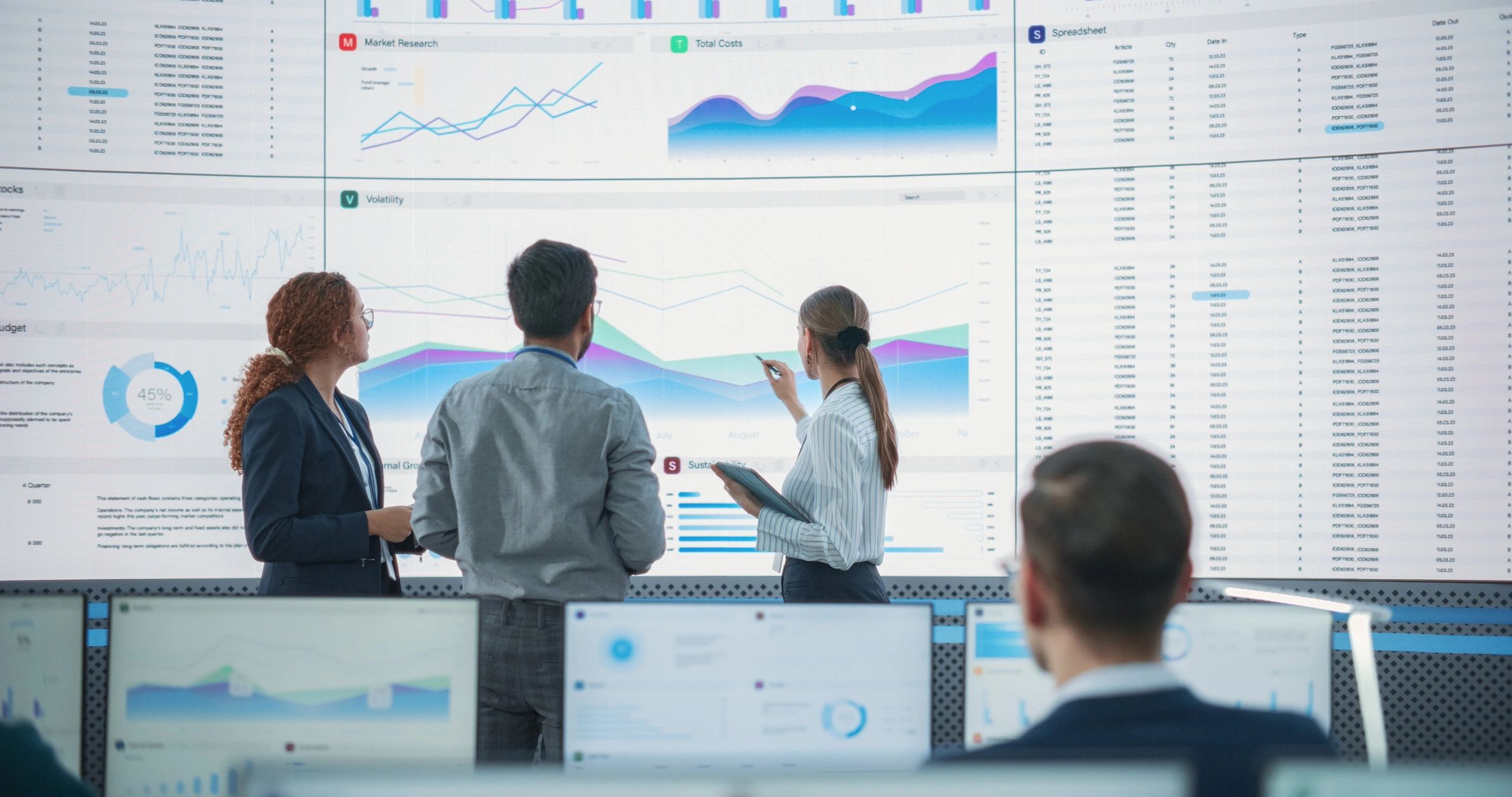 Team reviewing analytics dashboards in a monitoring office